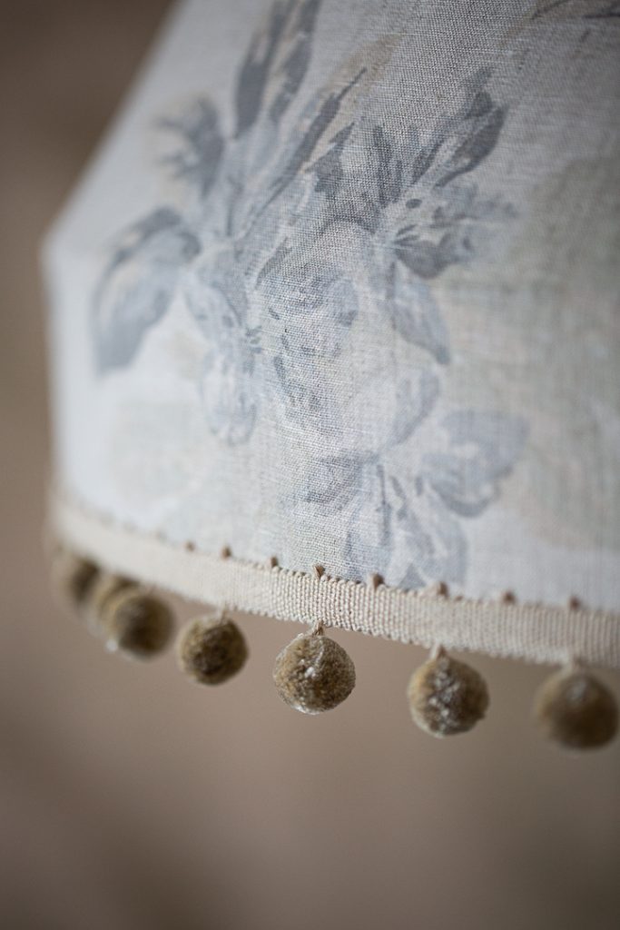 Lampshade showing the pom pom trim around the bottom edge