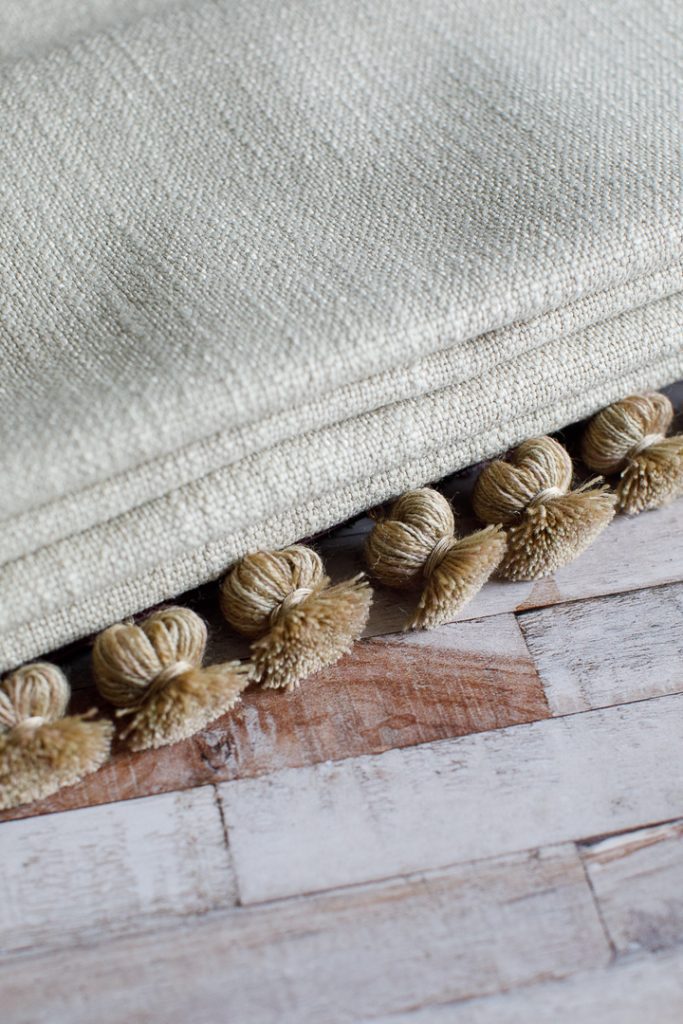Roman blind with natural onion tassel trimming on the edge